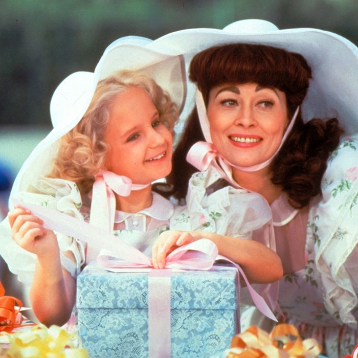 Daughter and mother with gifts in the movie Mommie Dearest