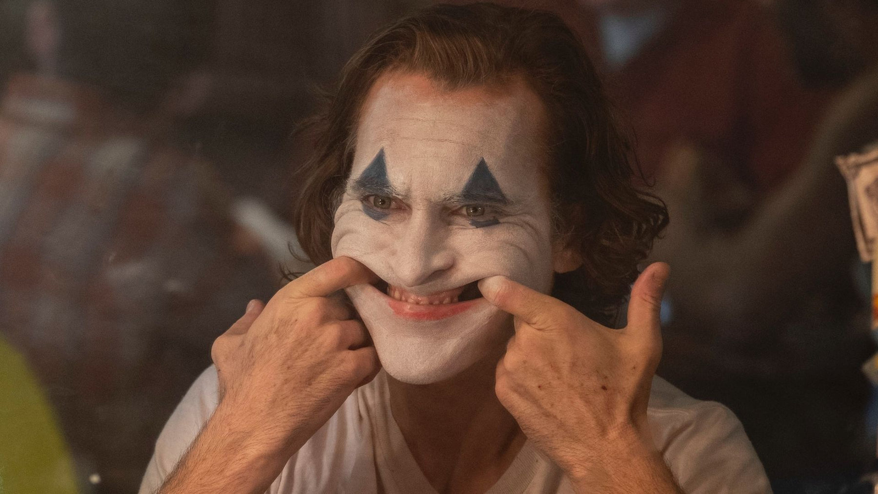 Stressed Joaquin Phoenix Joker trying to smile